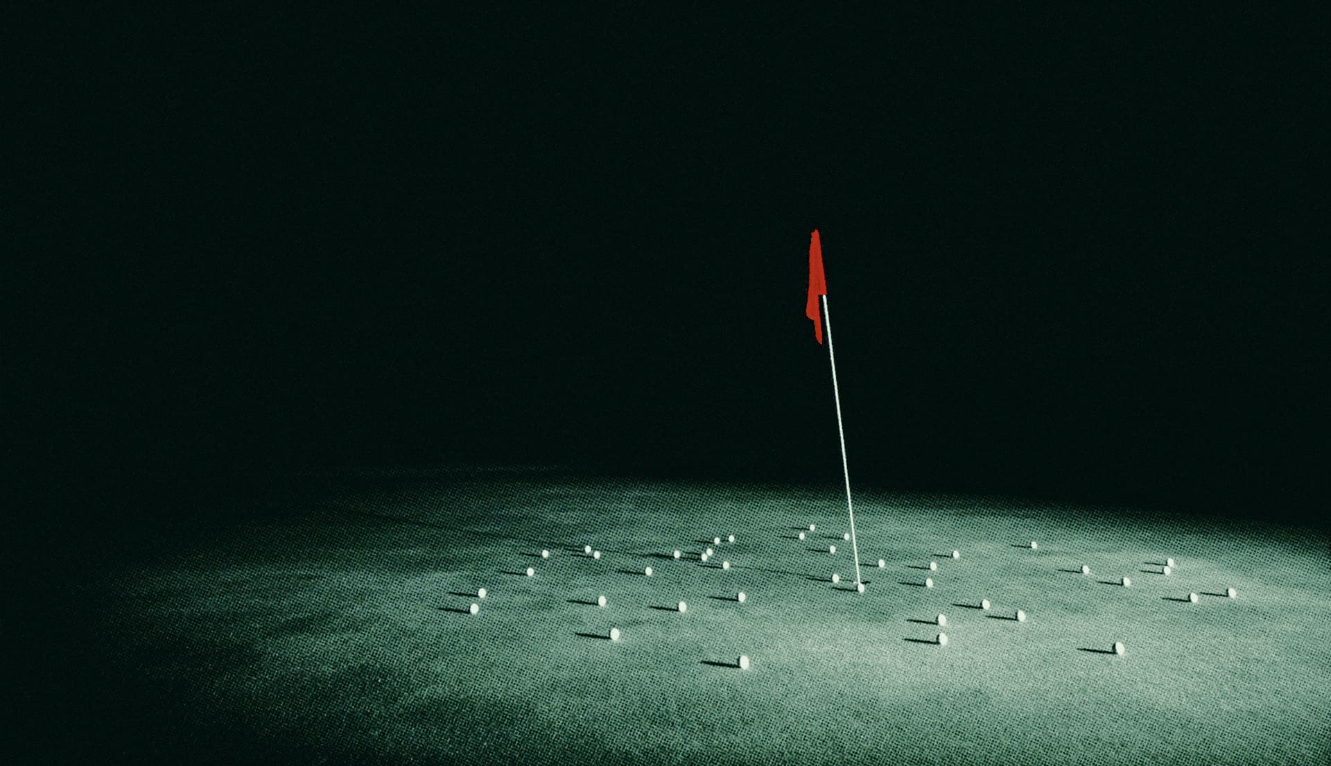 Indoor golf simulator with a red flag on the green and golf balls scattered on the floor
